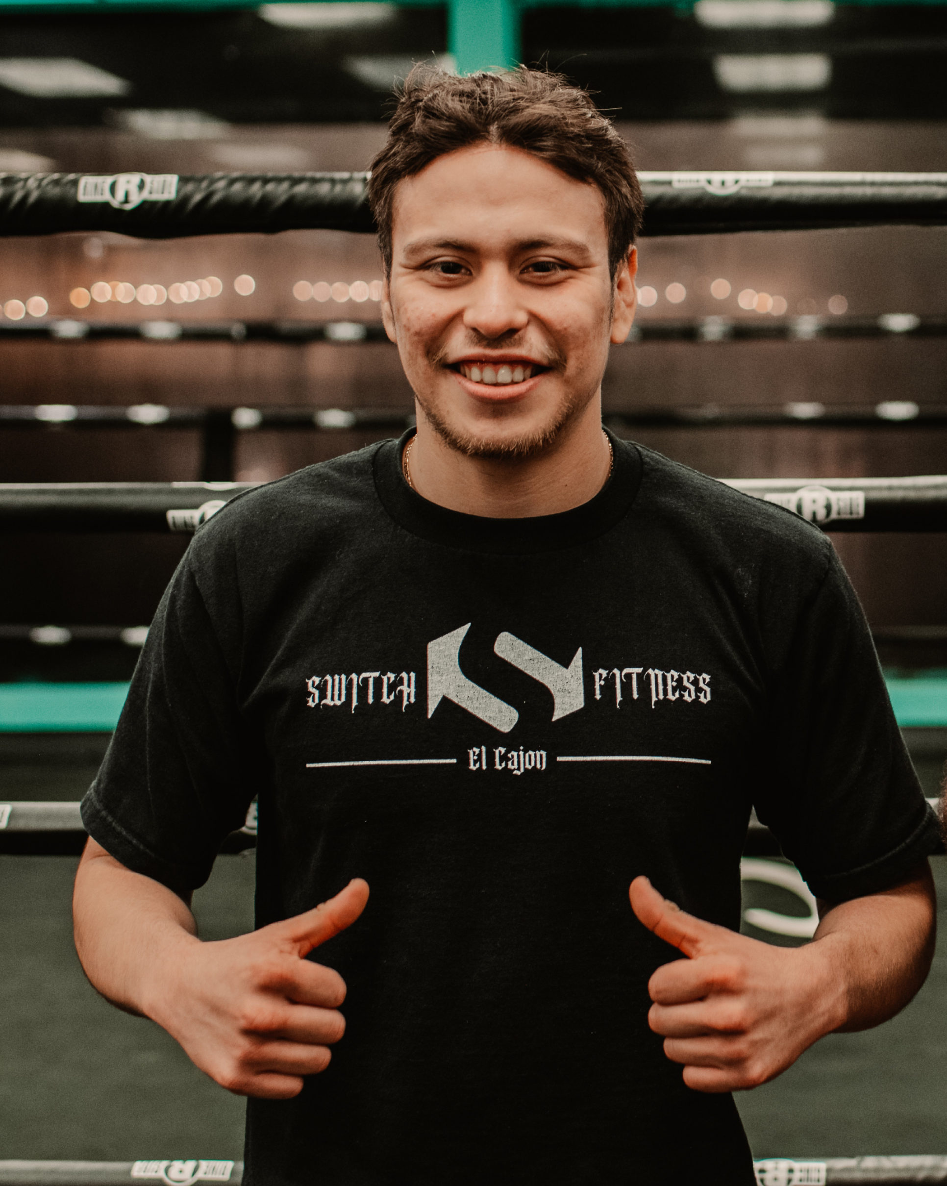 A member in a Switch Fitness shirt inside the boxing ring.
